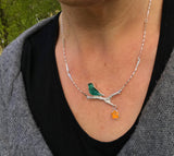 Bird necklace with dangling flower