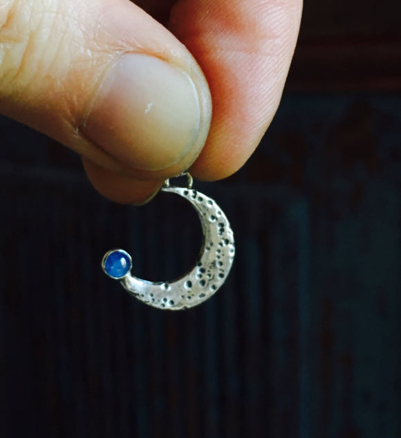 crescent moon pendant with blue sapphire